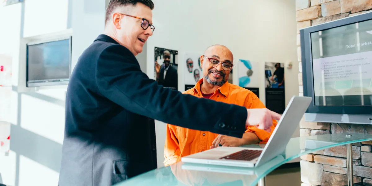 Owner talking with employee about project