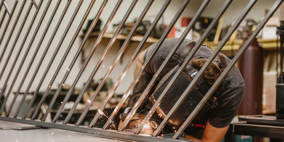 Welder working on angle metal